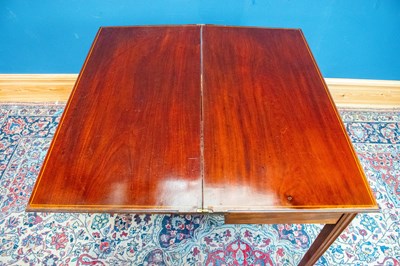 Lot 2537 - A Georgian mahogany fold over tea table with...