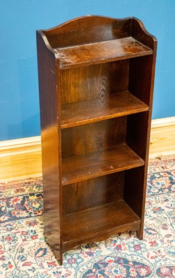 Lot 2494 - An oak freestanding bookcase with four fixed...