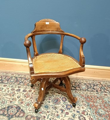 Lot 2423 - An early 20th century cane seated swivel...