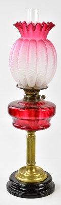 Lot 2204 - A Victorian oil lamp, the cranberry and clear...