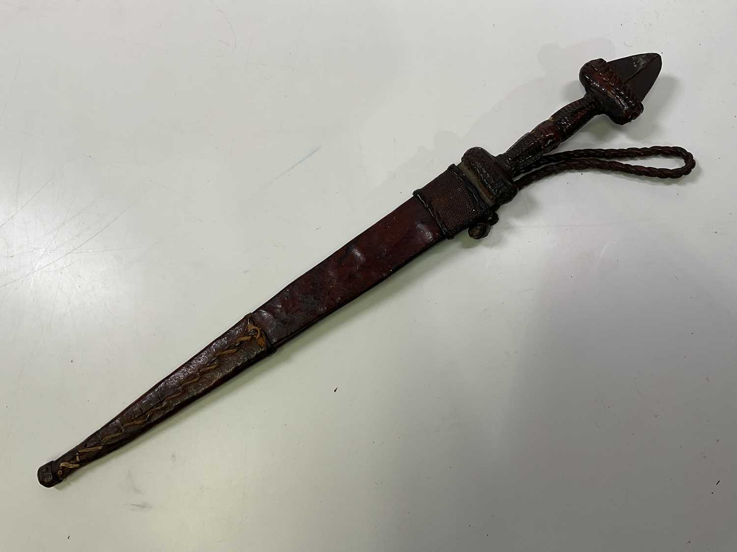 Lot 42 - An African dagger with leather and snakeskin...