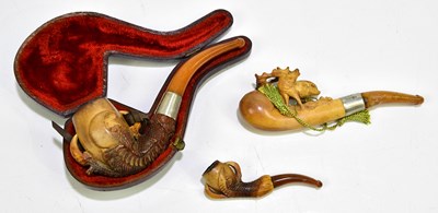 Lot 1053 - Three late 19th century Meerschaum pipes, one...