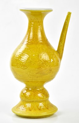 Lot 1063 - A Chinese yellow ground ewer, relief decorated...