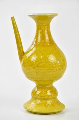 Lot 1063 - A Chinese yellow ground ewer, relief decorated...