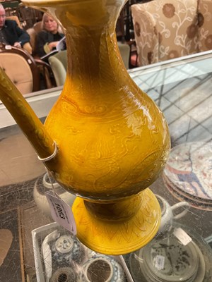 Lot 1063 - A Chinese yellow ground ewer, relief decorated...