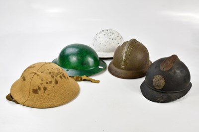 Lot 451 - Seven various military helmets including a...