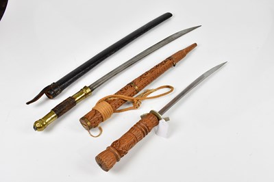 Lot 727 - An Indian sword with brass handle and carved...