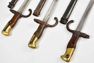 Lot 696 - Three French Gras bayonets with scabbards.