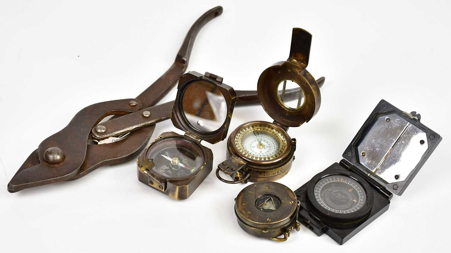 Lot 431 - Four military compasses, with a set of cast