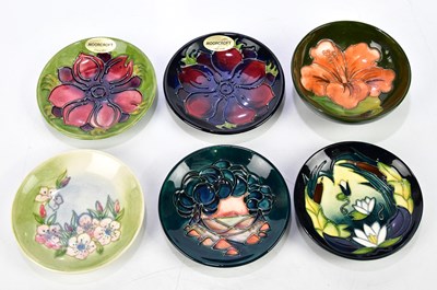 Lot 112 - MOORCROFT; four ceramic pin dishes including...