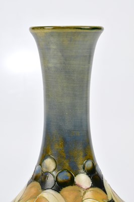 Lot 86 - WALTER MOORCROFT; a baluster vase with...