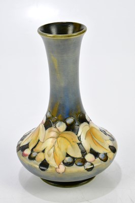 Lot 86 - WALTER MOORCROFT; a baluster vase with...
