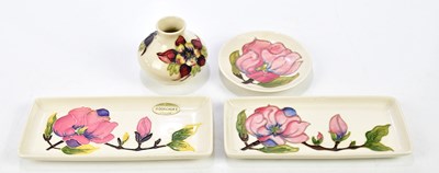 Lot 118 - MOORCROFT; four pieces including a pair of...