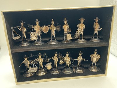 Lot 1074 - A set of twelve white metal miniature figures...