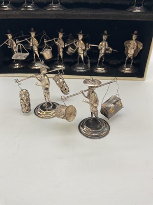 Lot 1074 - A set of twelve white metal miniature figures...