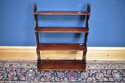 Lot 2487 - A reproduction mahogany hanging shelf, with...