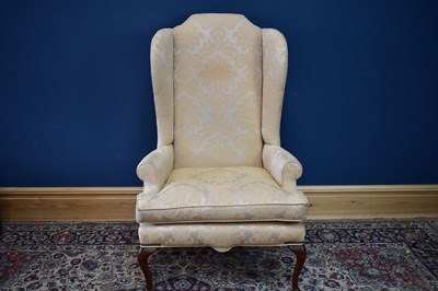 Lot 2405 - A reproduction wingback armchair upholstered...