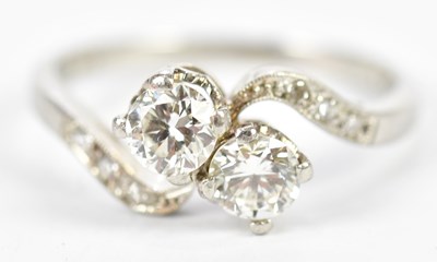 Lot 64 - A platinum and diamond crossover ring, each...