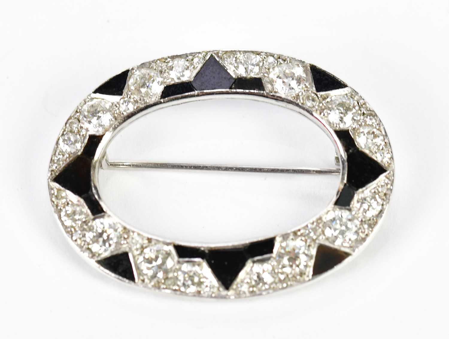 Lot 563 - A white metal and black onyx Art Deco designed...