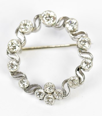 Lot 567 - A white metal and diamond pierced circular...