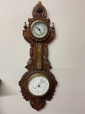 Lot 315 - A circa 1900 carved oak barometer with rope...