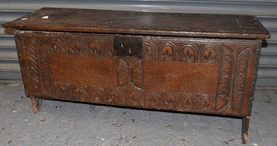 Lot 28 - A late 17th century carved oak six plank coffer.