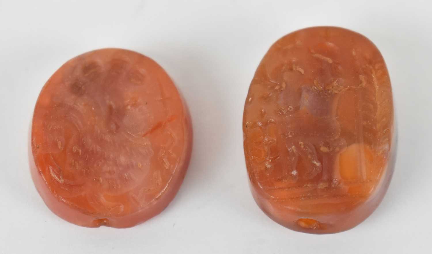 Lot 327 - Two carved agate stones or seals with incised...