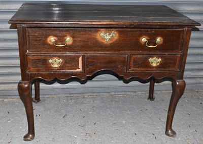 Lot 31 - A Georgian oak three drawer knee-hole side...