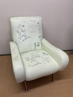 Lot 396 - ROCK & POP; a white faux leather chair signed...