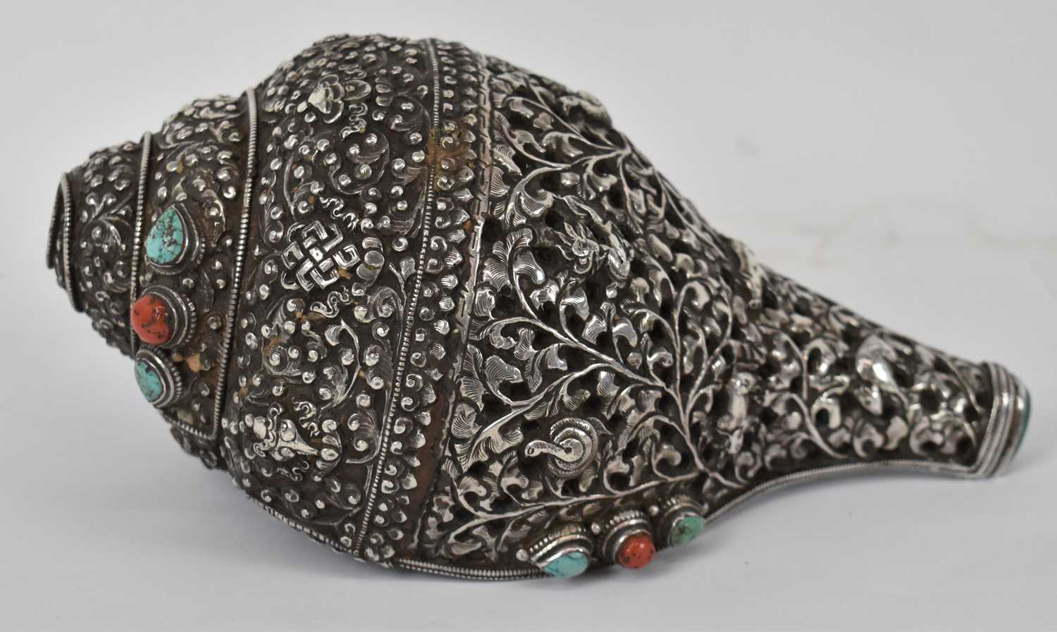 Lot 273 - A Tibetan silver mounted conch shell set with...