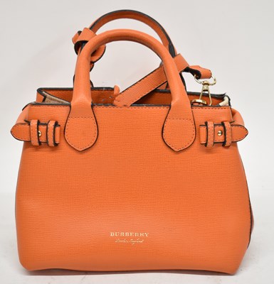 Lot 603 - BURBERRY; an orange textured leather small...