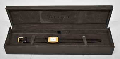 Lot 605 - GUCCI; a lady's gold tone cocktail watch with...