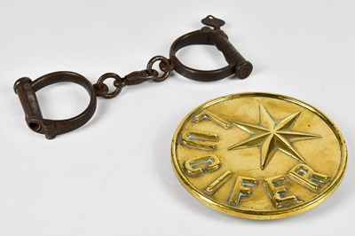 Lot 393 - A pair of vintage handcuffs, complete with key,...