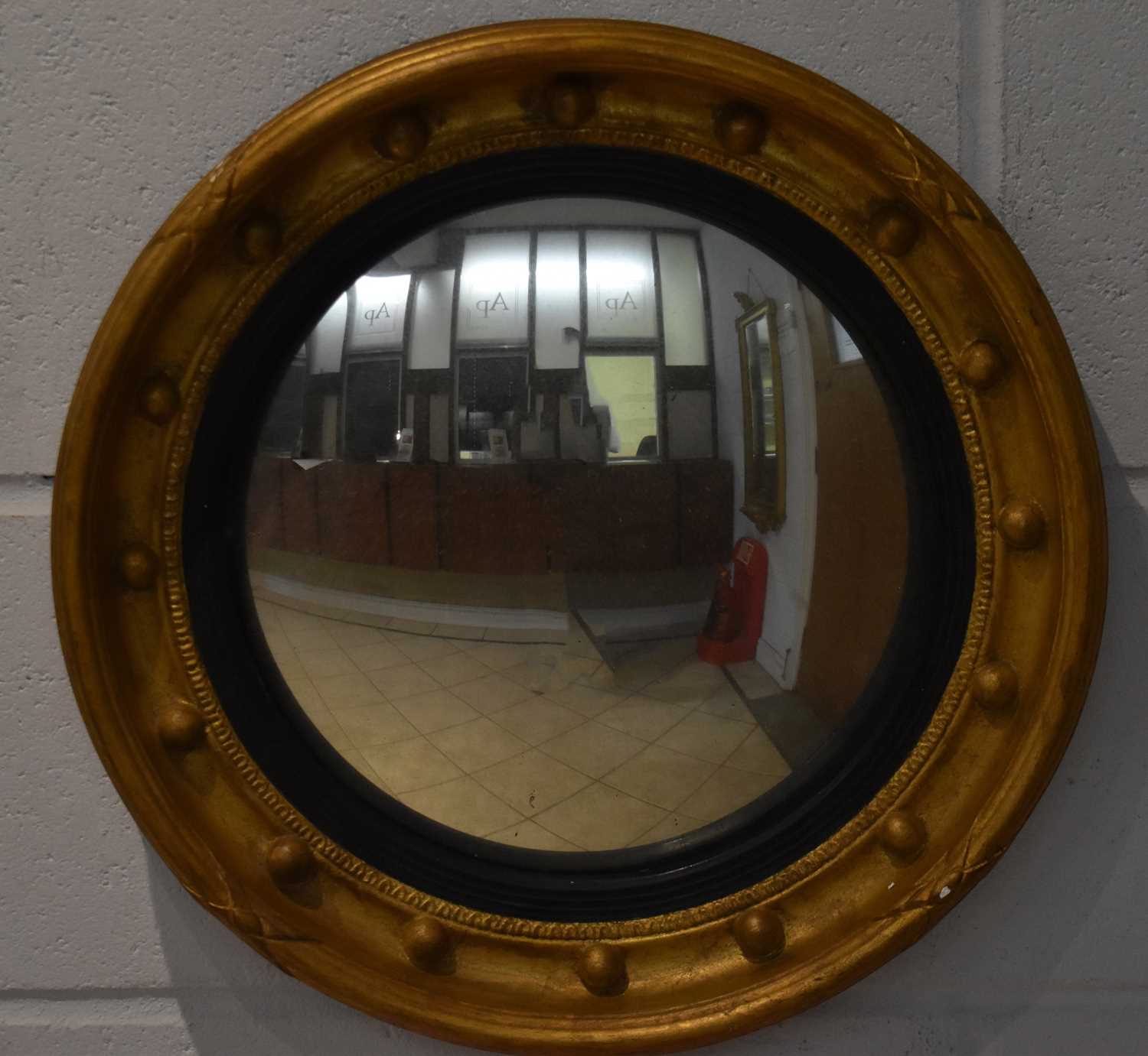 Lot 120 - A reproduction gilt framed convex style wall...