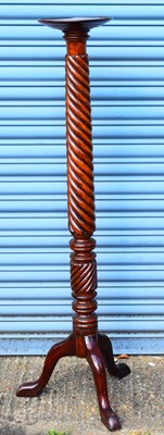 Lot 68 - A mahogany torchere with circular top on...