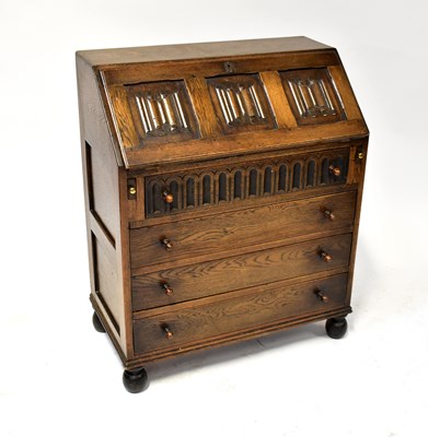 Lot 4 - An early 20th century oak priory-style bureau