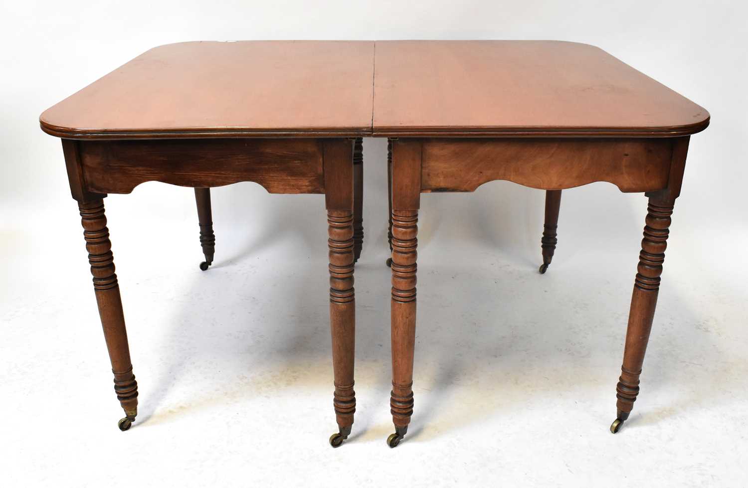 Lot 23 - A George III mahogany extending dining table...