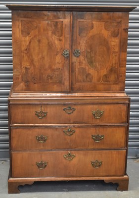 Lot 14 - An antique walnut cabinet on chest, the upper...