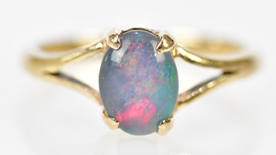 Lot 265 - A yellow metal and doublet opal dress ring,...