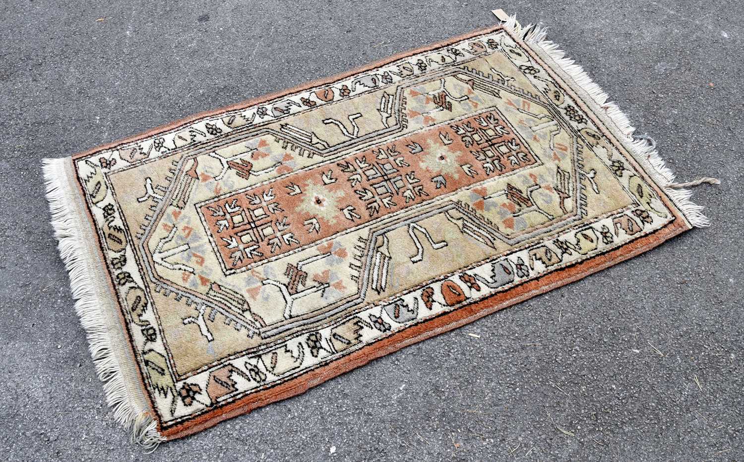 Lot 2291 - An Eastern style rug, 140cm x 88cm.