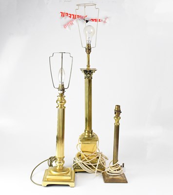 Lot 75 - Three brass column table lamps, height of...