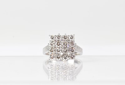 Lot 1048 - An 18ct white gold diamond cluster ring, with...