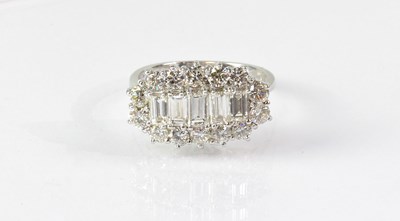 Lot 1047 - An 18ct white gold diamond cluster ring, with...