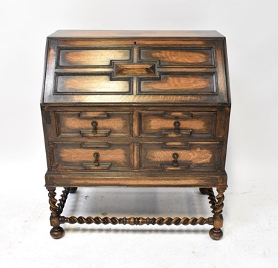 Lot 18 - An early 20th century oak bureau, the fall...