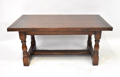 Lot 42 - A 20th century oak refectory-style draw-leaf...