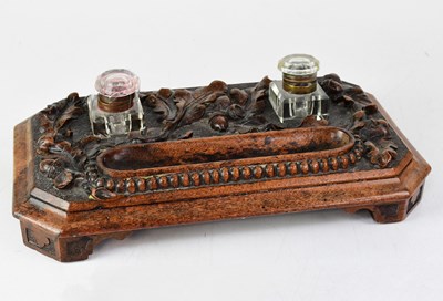 Lot 95 - A Victorian oak pen tray carved with oak...