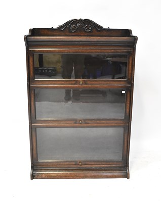 Lot 57 - An oak three-tier glazed bookcase, with...