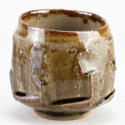 Lot 59 - BEN DODD; a faceted stoneware chawan covered...