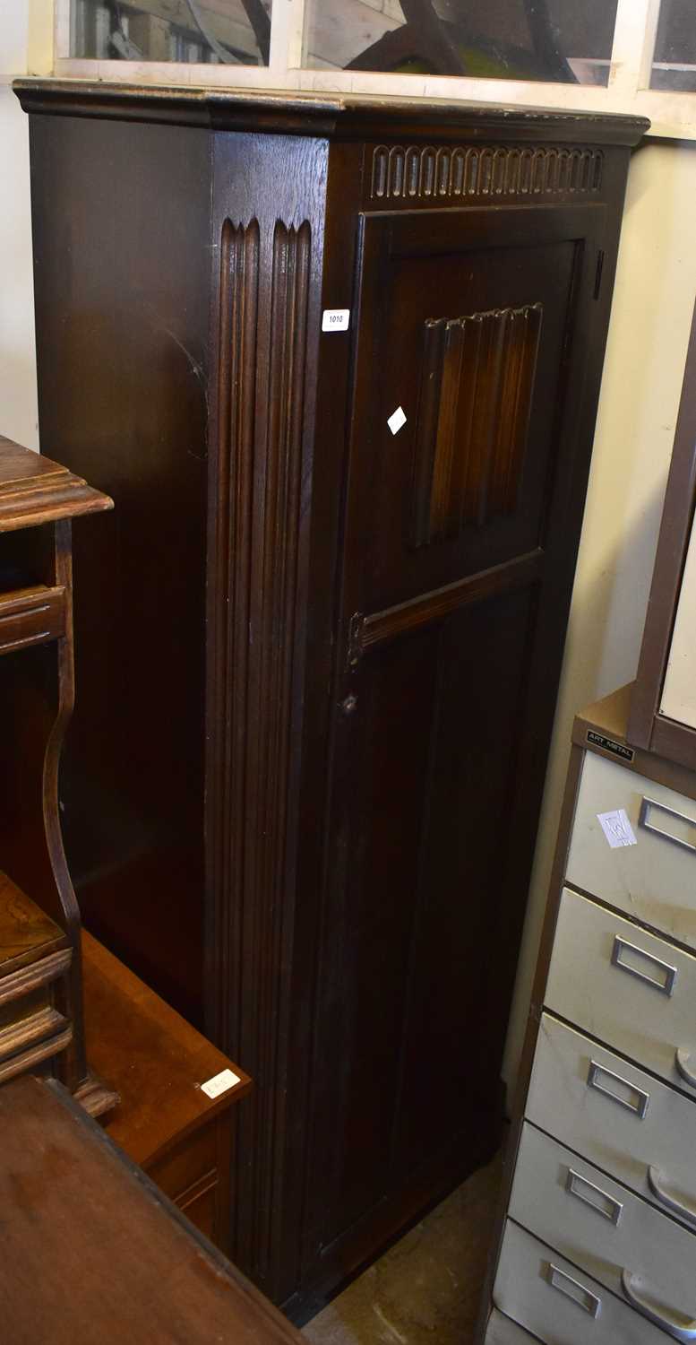 Lot 1010 - An oak hall robe, the single door with...