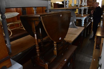 Lot 1118 - A reproduction oak drop-leaf gateleg dining...